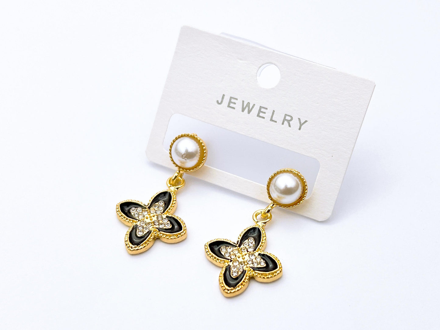 Golden pearl butterfly drop earrings with black enamel