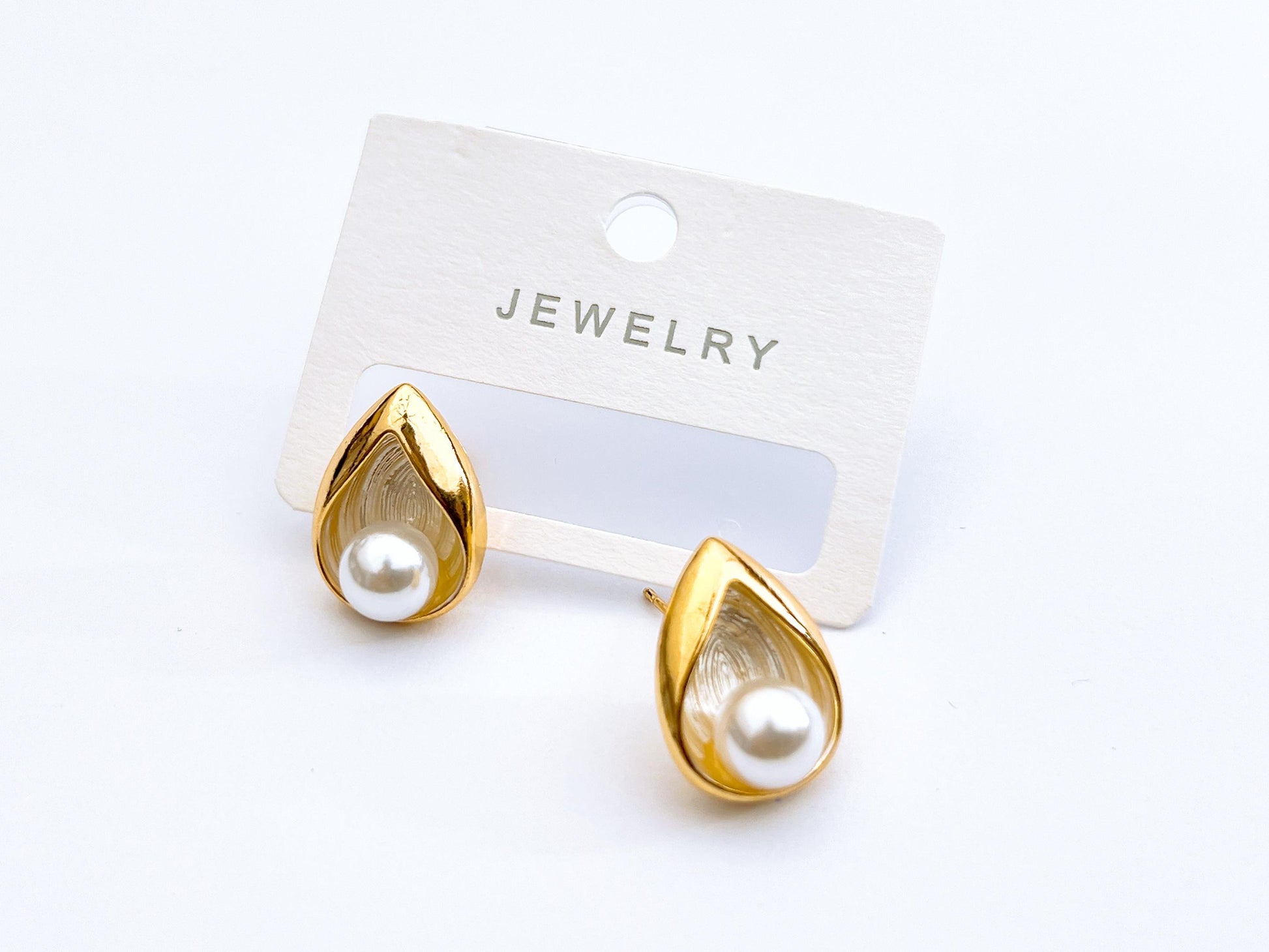 Golden pearl stud earrings with teardrop frame