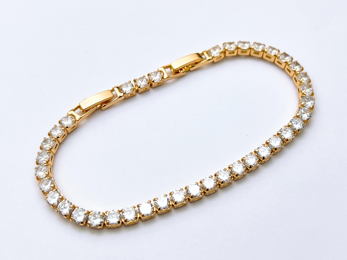 Golden tennis crystal bracelet with round stones